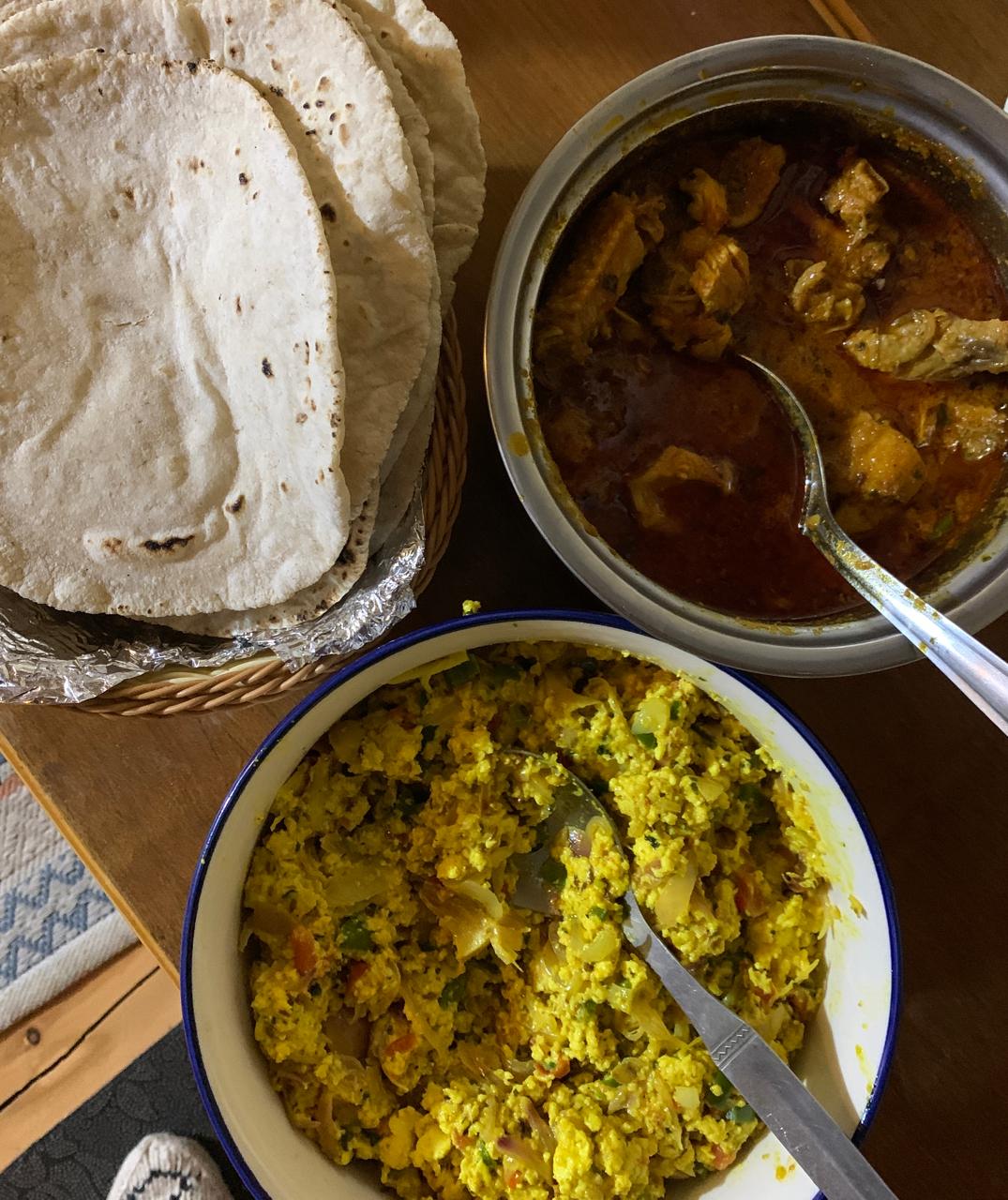 Home-cooked Indian meal of curry, scrambled paneer and fresh rotis