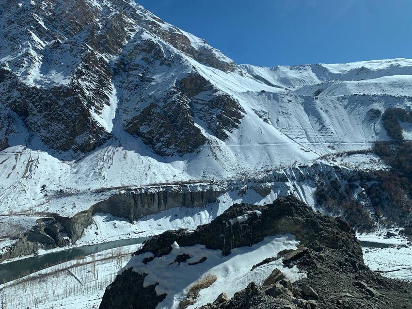 Snow-dusted cliffs rising above a river valley