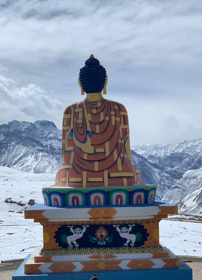 The Langza Buddha statue looking out over snow-covered peaks