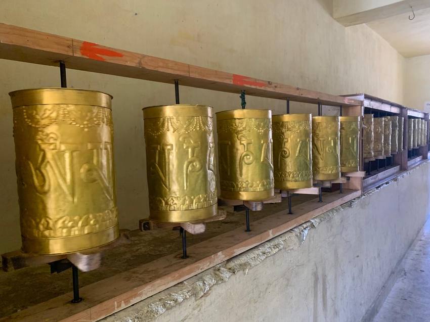 A row of golden prayer wheels
