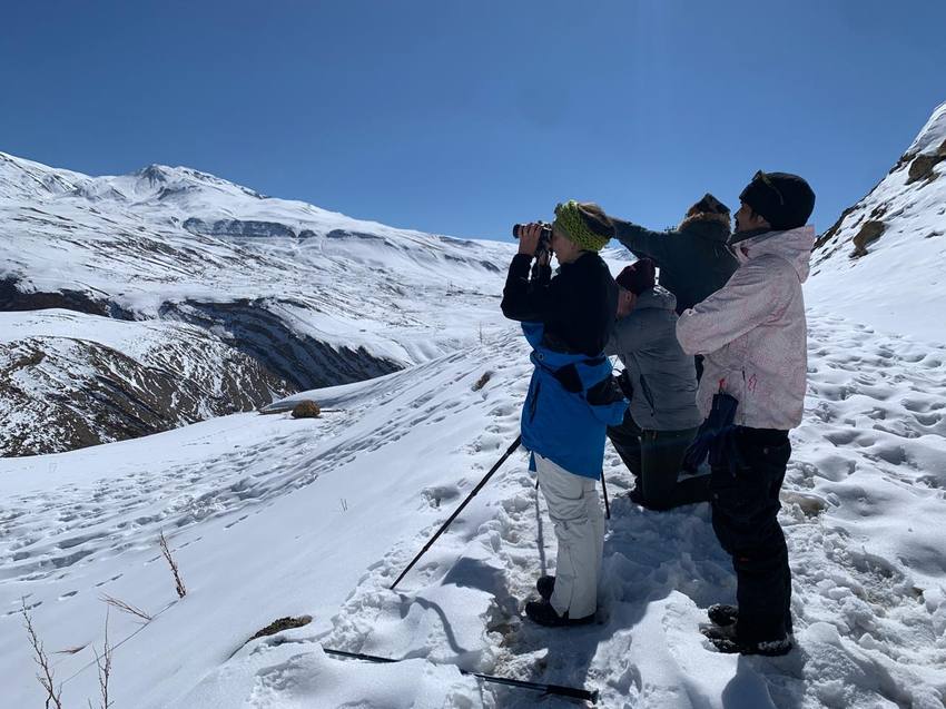 Guests scanning the slopes with binoculars